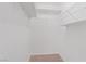 Walk in closet with carpeted floors and multiple white storage shelves at 9105 Marble Dr, Las Vegas, NV 89134