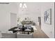 Bright, open dining room and living room space with elegant decor and modern lighting fixture at 9105 Marble Dr, Las Vegas, NV 89134