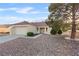 Charming single-story home featuring a two-car garage, desert landscaping, and a tile roof at 9105 Marble Dr, Las Vegas, NV 89134