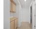 Hallway with tile floors, built-in storage, and bright white walls at 9105 Marble Dr, Las Vegas, NV 89134