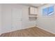Laundry room with laminate wood floors, storage cabinets and a window at 9105 Marble Dr, Las Vegas, NV 89134