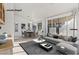 Spacious living room with large windows, an adjacent dining area, and modern decor at 9105 Marble Dr, Las Vegas, NV 89134