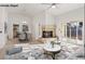 Open concept living room featuring a brick fireplace and sliding glass doors to the backyard at 9105 Marble Dr, Las Vegas, NV 89134