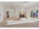 Spacious living room with a fireplace, backyard access, and views into the open kitchen and dining areas at 9105 Marble Dr, Las Vegas, NV 89134