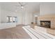 Bright living room featuring a brick fireplace, carpet flooring, and many windows at 9105 Marble Dr, Las Vegas, NV 89134
