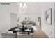 Open-concept living room featuring neutral decor, high ceilings, and carpet floors at 9105 Marble Dr, Las Vegas, NV 89134