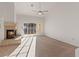 Spacious living room featuring a brick fireplace, ceiling fan, and sliding glass door to the backyard at 9105 Marble Dr, Las Vegas, NV 89134