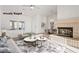Comfortable living room with brick fireplace, ample natural light, and access to other living spaces at 9105 Marble Dr, Las Vegas, NV 89134