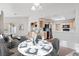 Open living area includes a dining table and a partial view of the kitchen with stainless steel appliances at 9105 Marble Dr, Las Vegas, NV 89134
