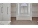 Bright bathroom featuring a soaking tub under a large arched window and access to walk-in closets at 9205 Desert Village Ave, Las Vegas, NV 89147