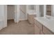 Well-lit bathroom with double sinks, vanities and adjacent walk-in closet at 9205 Desert Village Ave, Las Vegas, NV 89147