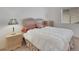 Bright bedroom with a rattan bedframe, side tables and large window at 9205 Desert Village Ave, Las Vegas, NV 89147