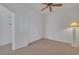 Bright bedroom featuring a ceiling fan and neutral carpet at 9205 Desert Village Ave, Las Vegas, NV 89147