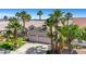 Charming home featuring a well-manicured lawn, desert landscaping, and a two-car garage at 9205 Desert Village Ave, Las Vegas, NV 89147