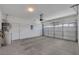 Clean garage featuring white door, bright lighting, and a water heater at 9205 Desert Village Ave, Las Vegas, NV 89147