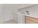 Well-lit laundry room with washer, dryer, storage cabinet, a countertop, and access to outside at 9205 Desert Village Ave, Las Vegas, NV 89147