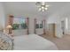 Comfortable main bedroom with views from dual windows and traditional-style furnishings at 9205 Desert Village Ave, Las Vegas, NV 89147