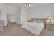 Bright main bedroom has a ceiling fan, plush carpet, and ample natural light at 9205 Desert Village Ave, Las Vegas, NV 89147