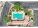 Aerial view of the community pool, with landscaping and a building with tile roof at 927 Clear Diamond Ave, Las Vegas, NV 89123