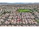 Aerial view of a neighborhood with many single-Gathering homes, landscaping, and desert mountains in the background at 927 Clear Diamond Ave, Las Vegas, NV 89123