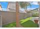 The backyard has a privacy wall, a covered patio, and artificial grass at 927 Clear Diamond Ave, Las Vegas, NV 89123