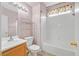 Well-lit bathroom with a shower-tub combo, toilet, and storage shelving unit at 927 Clear Diamond Ave, Las Vegas, NV 89123