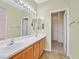 Bathroom featuring double sinks, an updated vanity, and a walk-in closet at 927 Clear Diamond Ave, Las Vegas, NV 89123