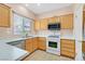 Well-lit kitchen featuring white appliances, countertops, and ample cabinet space at 927 Clear Diamond Ave, Las Vegas, NV 89123