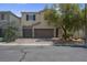 Inviting two-story home featuring a well-maintained front yard, dual-car garage and cozy curb appeal at 9840 Chief Sky St, Las Vegas, NV 89178