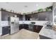 Kitchen with stainless steel appliances, granite countertops, and dark wood cabinetry at 9840 Chief Sky St, Las Vegas, NV 89178