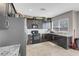 Kitchen with dark cabinets, stainless steel appliances, granite counters, and white subway tile backsplash at 9840 Chief Sky St, Las Vegas, NV 89178
