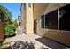Backyard with a paved patio and greenery with a view of the house and an air conditioning unit at 10449 Yew Blossom Ave, Las Vegas, NV 89166