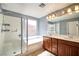 Bathroom features a tub, separate shower, double sinks, and ample lighting at 10449 Yew Blossom Ave, Las Vegas, NV 89166