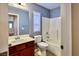 Bathroom featuring vanity with sink, toilet, and a shower-tub combo with white tiling at 10449 Yew Blossom Ave, Las Vegas, NV 89166
