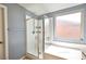 Bright bathroom with glass-enclosed shower, soaking tub, and natural light at 10449 Yew Blossom Ave, Las Vegas, NV 89166
