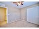 Bedroom with beige walls, carpet flooring, and a ceiling fan at 10449 Yew Blossom Ave, Las Vegas, NV 89166