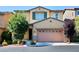 Charming two-story home featuring a stucco facade, well-manicured landscaping, and an attached two-car garage at 10449 Yew Blossom Ave, Las Vegas, NV 89166