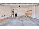 Spacious two-car garage with ample space for storage, a water heater, and a door to access the house at 10449 Yew Blossom Ave, Las Vegas, NV 89166