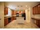 Well-lit kitchen features an island, stainless steel appliances, granite countertops, and ample cabinet space at 10449 Yew Blossom Ave, Las Vegas, NV 89166
