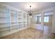 Bright room features tile floors, a built-in bookshelf and a modern chandelier at 10449 Yew Blossom Ave, Las Vegas, NV 89166