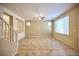 Spacious living area featuring tile floors, recessed lighting, and an open floor plan with views to the staircase at 10449 Yew Blossom Ave, Las Vegas, NV 89166