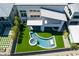 Aerial view of a home featuring a modern pool, swim up bar, jacuzzi and well-manicured lawn at 10748 Steel Ridge Ct, Las Vegas, NV 89135