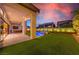 Inviting outdoor space featuring a built-in grill, pool, turf, covered patio, and privacy wall at 10748 Steel Ridge Ct, Las Vegas, NV 89135