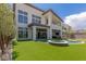 Backyard with pool, hot tub, artificial grass, and patio area at 10748 Steel Ridge Ct, Las Vegas, NV 89135