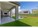 Inviting backyard with covered patio and outdoor kitchen, leading to pool with spa, perfect for outdoor enjoyment at 10748 Steel Ridge Ct, Las Vegas, NV 89135