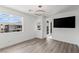 Bright bedroom with an attached entrance to the balcony, TV, and views of the outside at 10748 Steel Ridge Ct, Las Vegas, NV 89135