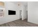 Bedroom featuring modern light fixture, flat screen tv, and wood flooring at 10748 Steel Ridge Ct, Las Vegas, NV 89135