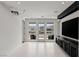 Versatile bonus room with a projector screen, multiple windows, and tile floors at 10748 Steel Ridge Ct, Las Vegas, NV 89135