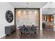 Modern dining room featuring stylish chairs, unique lighting, and decorative art piece at 10748 Steel Ridge Ct, Las Vegas, NV 89135