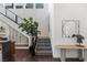 Bright entryway with modern staircase, stone accent wall, and stylish decor at 10748 Steel Ridge Ct, Las Vegas, NV 89135